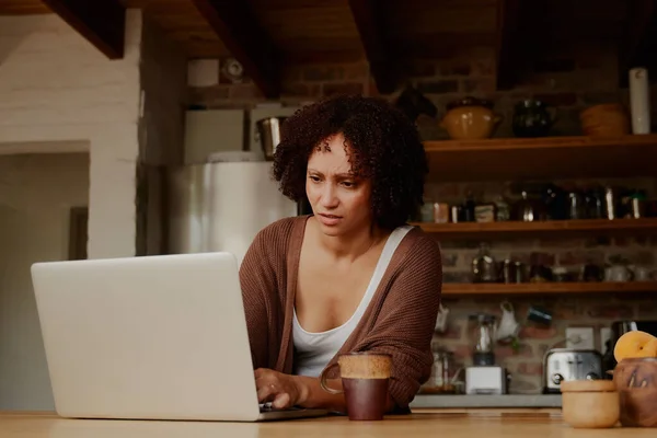 Young Biracial Woman Casual Clothing Concentrating While Working Laptop Kitchen — Stok fotoğraf