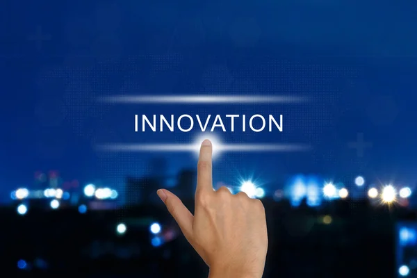 Hand pushing innovation button on touch screen — Stock Photo, Image