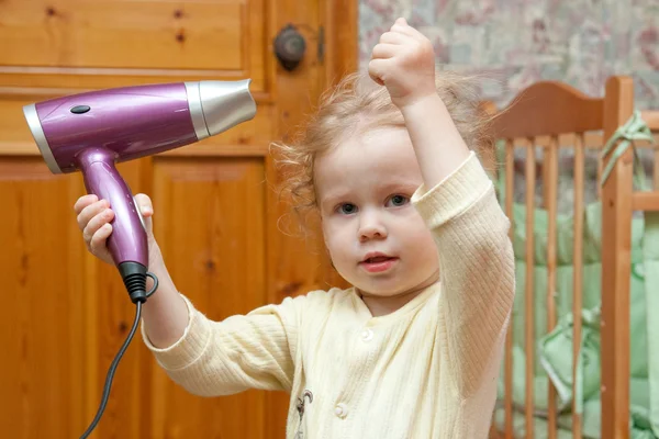 Small girl with hairdryer — Stock Photo, Image
