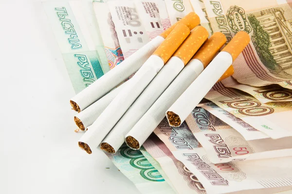 Money and group of cigarettes — Stock Photo, Image