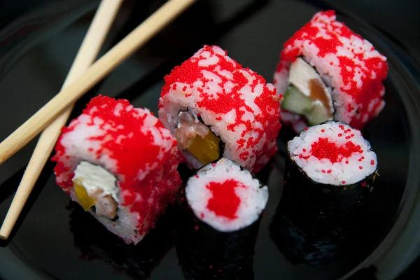 Seafood. Traditional sushi and rolls on the dish.