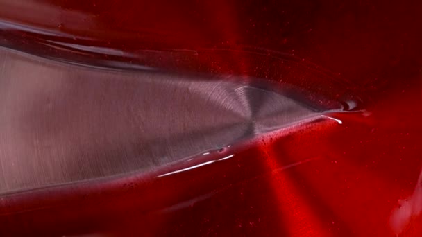 Close-up van een rood glazuur op een stalen pan. Verdeel een karamel glazuur met een witte siliconen spatel — Stockvideo