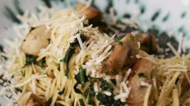 Close-up rotating of cooked pasta fresca on plate with mushrooms and cheese. Hot spaghetti — Stock Video