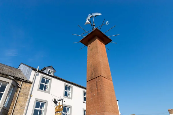 Wind vane in towne center on a beautiful Spring day.  Pooley Bridge, England.