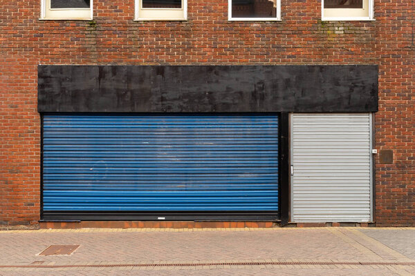 Closed shop doors in English town center.
