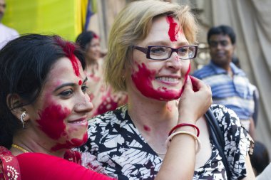 A foreign tourist gets a warm cultural greeting with vermilion