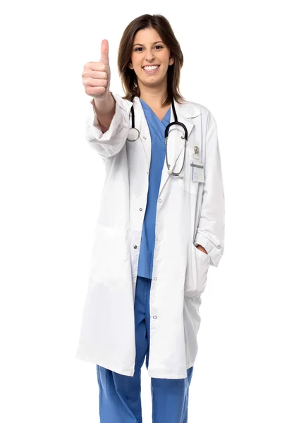Smiling doctor giving a thumbs up gesture — Stock Photo, Image