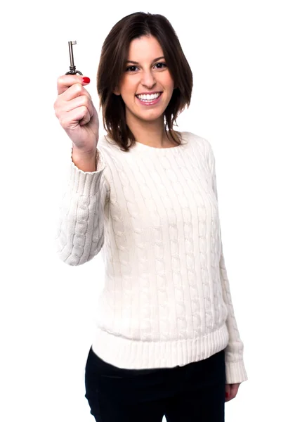 Woman holding up a house key — Stock Photo, Image