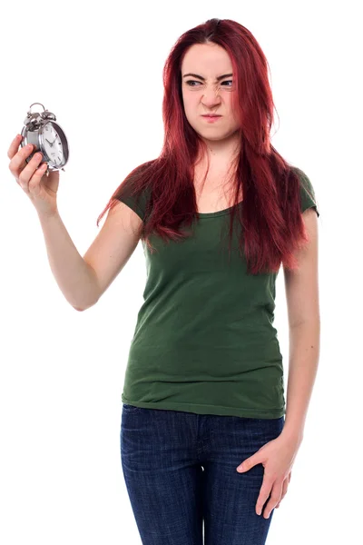 Woman glaring at her alarm clock — Stock Photo, Image