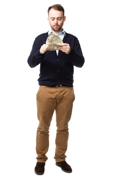 Young man eyeing up a handful of money — Stock Photo, Image