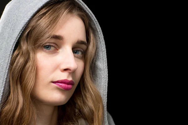 Beautiful blond woman wearing a hood — Stock Photo, Image