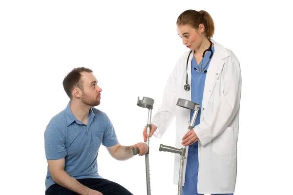 Male Patient Gets Crutches from Woman Doctor — Stock Photo, Image