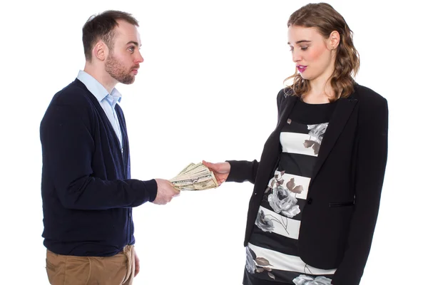 Businessman gives businesswoman cash — Stock Photo, Image