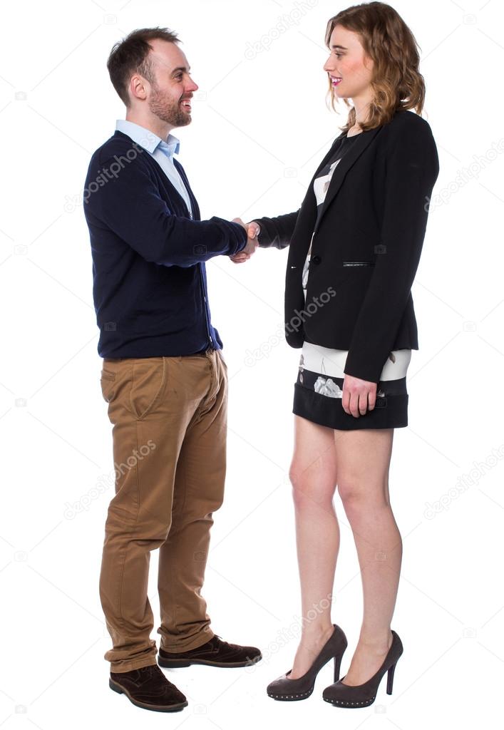 Young man and an attractive woman shaking hands