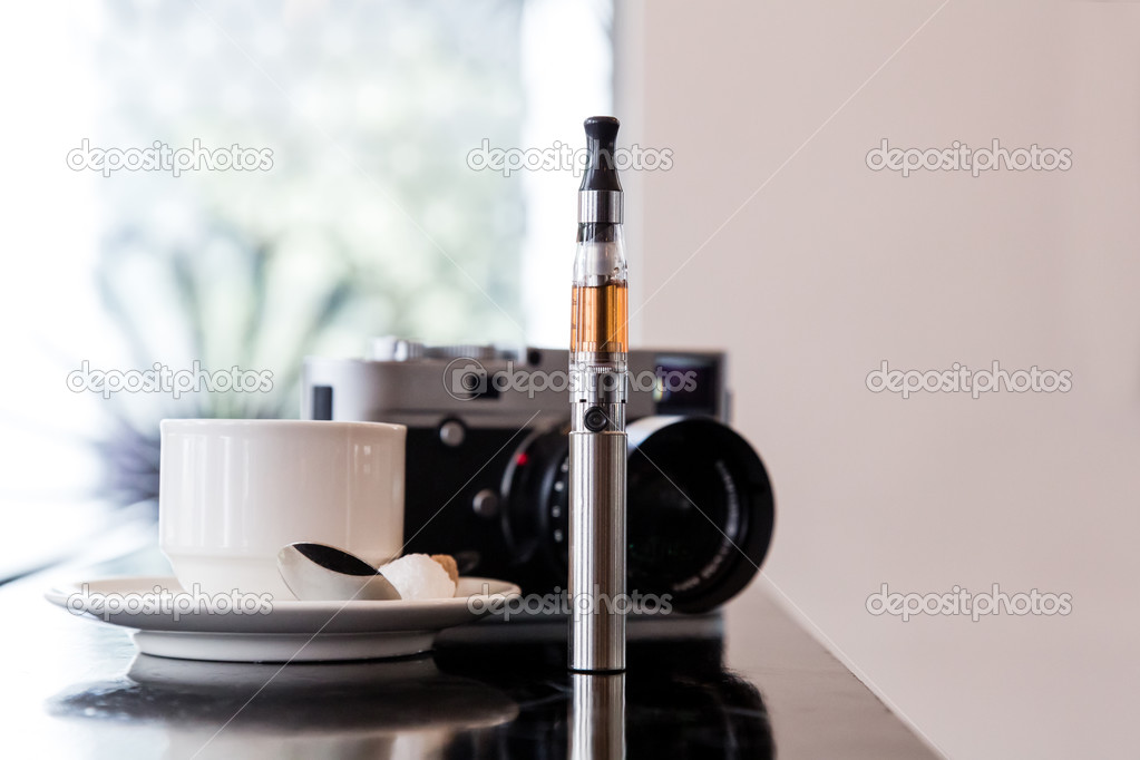 E-cigarette on a bar with coffee and a camera