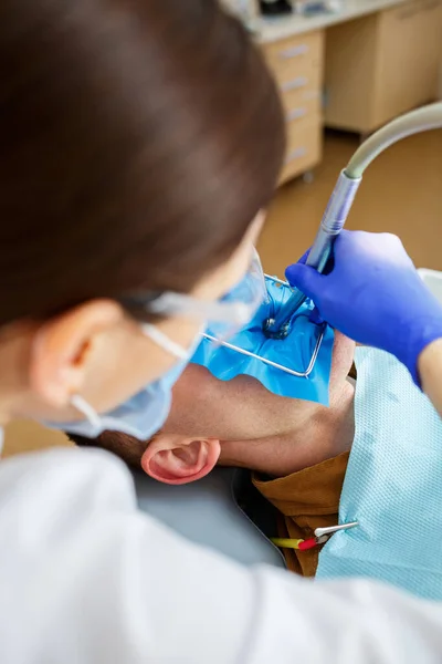 Male Patient Sits Dentist Chair Receives Teeth Restoration Female Dentist — Stock Photo, Image