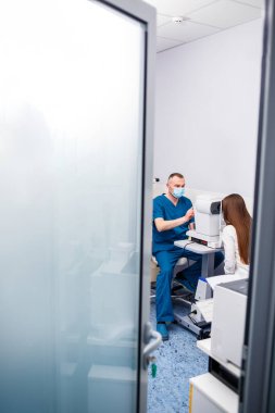 Klinikte bir optometrist vizyon üzerine çalışıyor. Oftalmoloji, tıbbi teşhis..