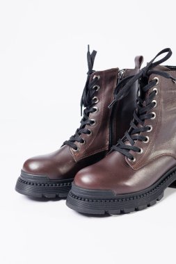 Graceful women's leather demi-season ankle boots with low heels. Studio photo for the catalog of the new collection of women's shoes 2022