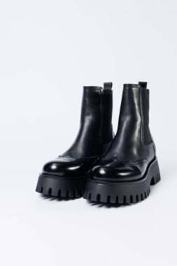 Women's black boots with genuine leather on a rough sole without laces. New collection of women's spring shoes
