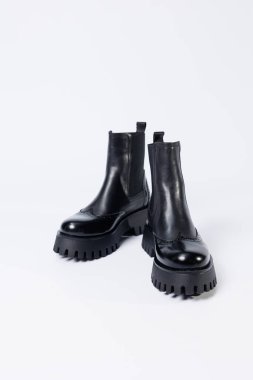 Women's black boots with genuine leather on a rough sole without laces. New collection of women's spring shoes