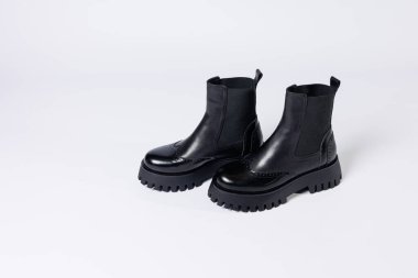 Women's black boots with genuine leather on a rough sole without laces. New collection of women's spring shoes