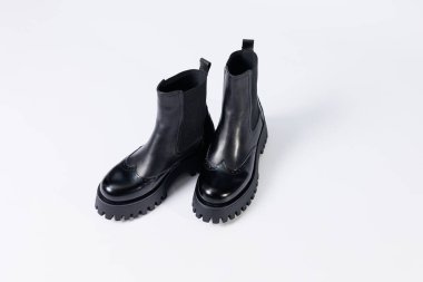 Women's black boots with genuine leather on a rough sole without laces. New collection of women's spring shoes