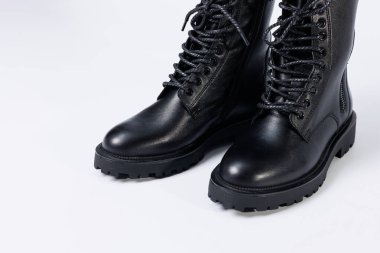 Black women's leather lace-up boots from the new collection on a white background from leather autumn-winter 2022. Boots close-up