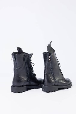 Black women's leather lace-up boots from the new collection on a white background from leather autumn-winter 2022. Boots close-up