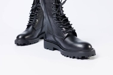 Black women's leather lace-up boots from the new collection on a white background from leather autumn-winter 2022. Boots close-up