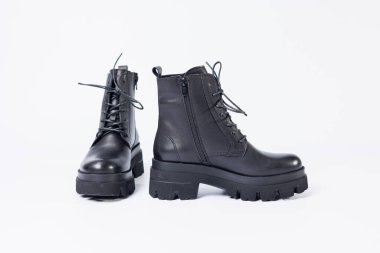 Women's black leather boots on a white background. Shoes and options for its layout. Autumn shoes. Boots. Autumn boots. Shoes close up