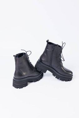 Women's black leather boots on a white background. Shoes and options for its layout. Autumn shoes. Boots. Autumn boots. Shoes close up