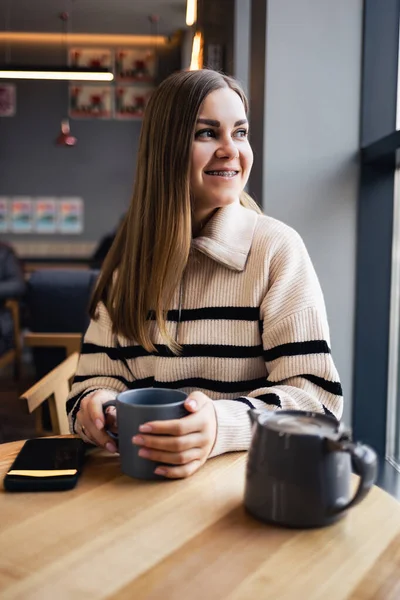 Ung Smuk Kvinde Drikker Kaffe Kigger Vinduet Mens Hun Sidder - Stock-foto