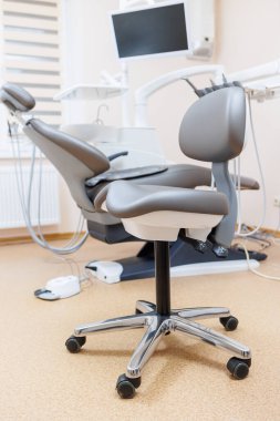 Hastaları kabul etmek için yeni bir koltuğu olan modern şık parlak dişçi ofisi. seçici odak