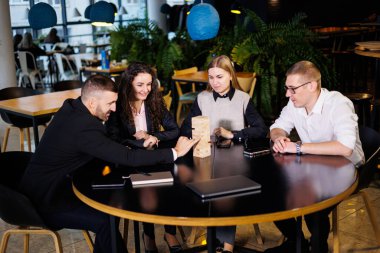 Mola sırasında ofisteki bir grup iş arkadaşı oyun jengası oynuyorlar. Arkadaşlar için eğlenceli masa oyunları