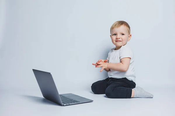 Ragazzo Intelligente Anni Siede Con Computer Portatile Uno Sfondo Bianco — Foto Stock