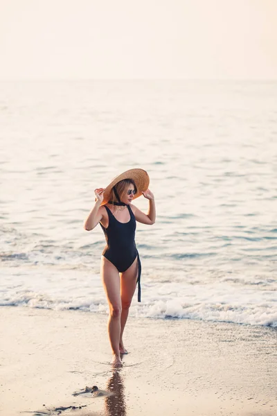 Mooi Meisje Een Zwart Badpak Hoed Een Zandstrand Aan Zee — Stockfoto