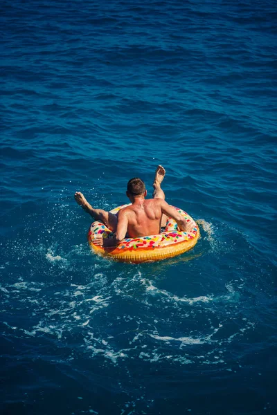 Man Floats Inflatable Ring Sea Blue Water Vacation Sea Sunny — Stock Photo, Image