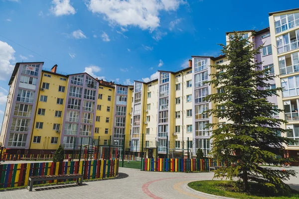 New residential high-rise buildings. Apartments with balconies in a new area. Modern residential buildings. Children\'s playground in the courtyard of a residential building.