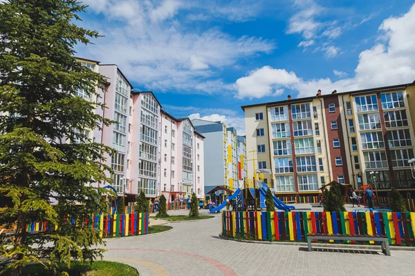 New residential high-rise buildings. Apartments with balconies in a new area. Modern residential buildings. Children\'s playground in the courtyard of a residential building.
