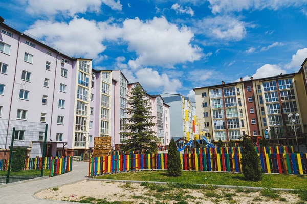 New residential high-rise buildings. Apartments with balconies in a new area. Modern residential buildings. Children\'s playground in the courtyard of a residential building.