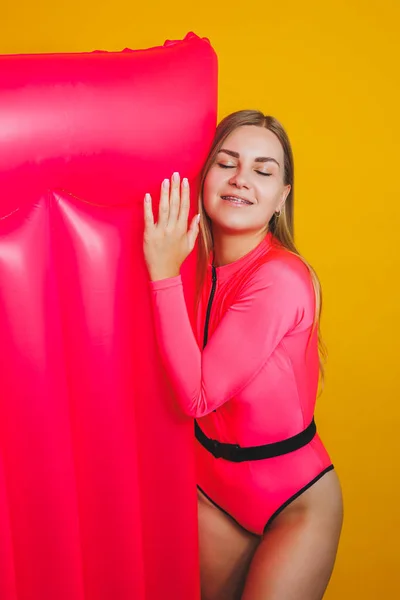 Young Slender Woman Pink Swimsuit Yellow Background Girl Inflatable Mattress — Zdjęcie stockowe