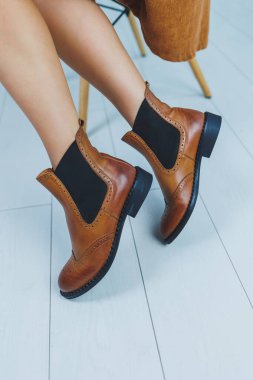 Kahverengi deri çizmeli kadın bacaklarını kapat. Kadın deri ayakkabılarının yeni sonbahar koleksiyonu 2022