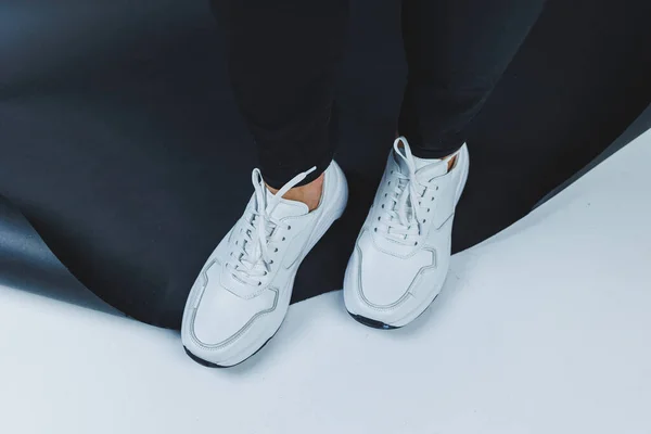 Men's casual white shoes made of genuine leather, men on shoes in white sneakers. High quality photo