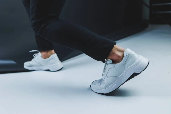 Men's casual white shoes made of genuine leather, men on shoes in white sneakers. High quality photo