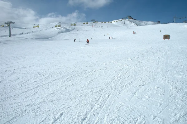 Ski slope and skiers — Stock Photo, Image