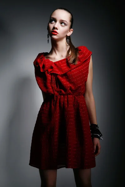 Pretty woman in red dress looking up — Stock Photo, Image