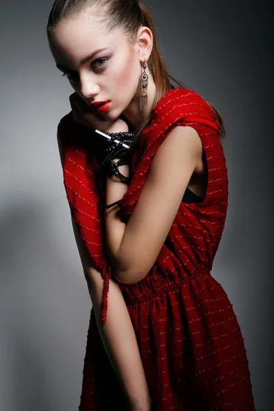 Beautiful woman in red dress looking at camera — Stok fotoğraf