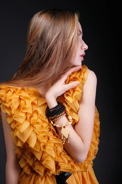 Profile of young woman in yellow dress — Stock Photo, Image