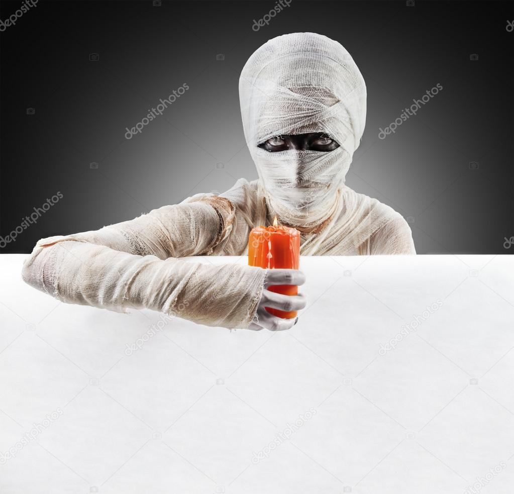 Halloween mummy with a candle