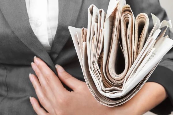 Newspaper about business close-up in hand — Stock Photo, Image